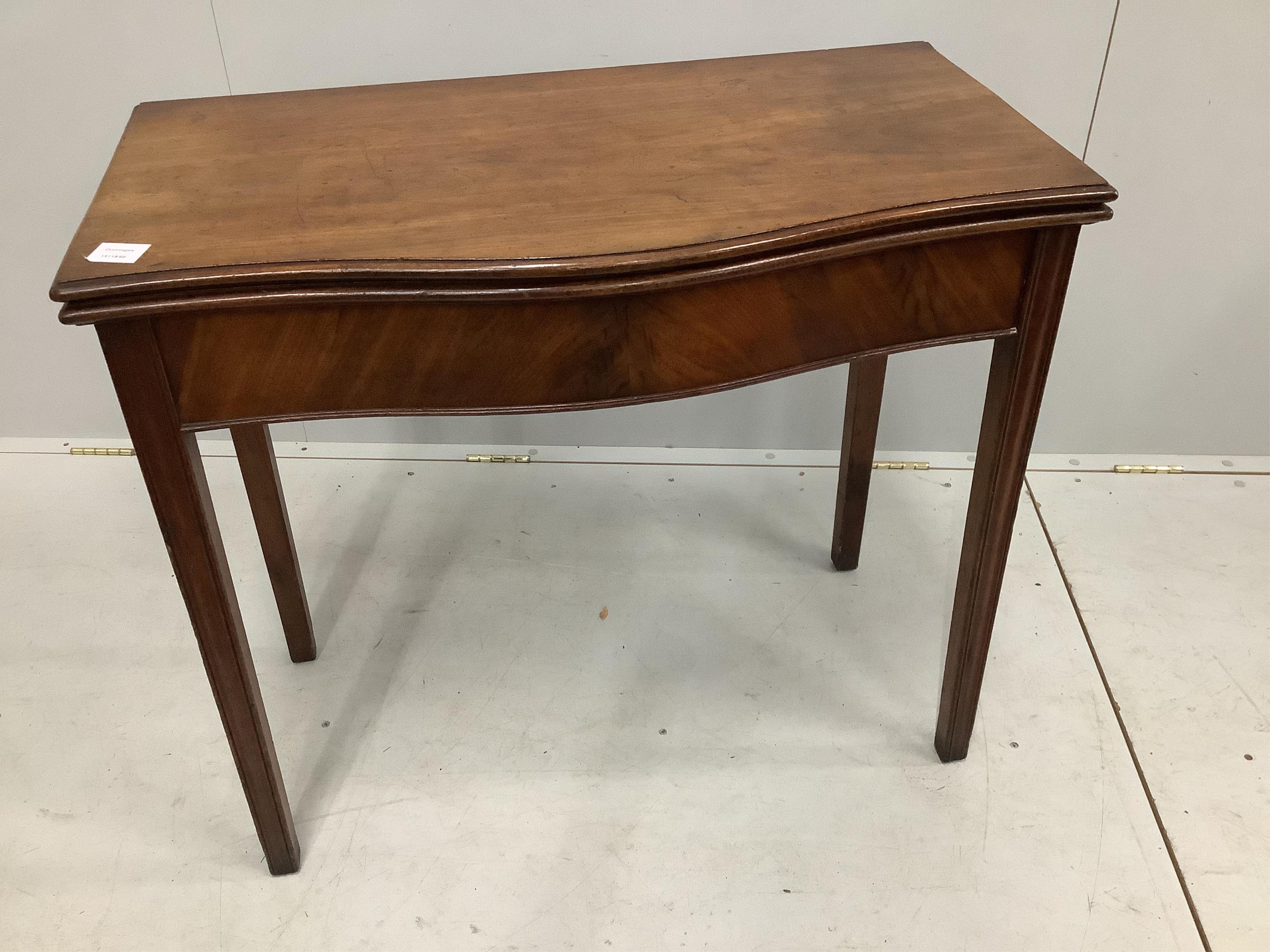 A George III mahogany serpentine fronted folding tea table, width 86cm, depth 46cm, height 75cm. Condition - fair